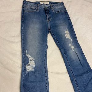 Hidden Flared bottom jeans with rips in knees